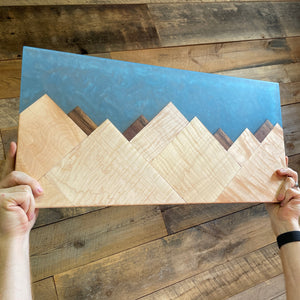 curly maple and walnut mountains with a blue epoxy sky that can be used as an art piece or charcuterie board