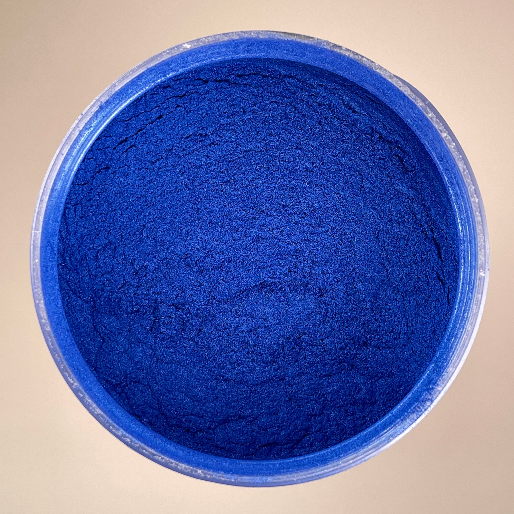 dark deep blue birds eye view shot of mica powder pigment 