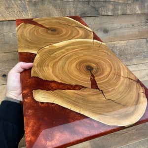charcuterie example board with large chamfer showing different swirls of red epoxy colour and two elm cookies