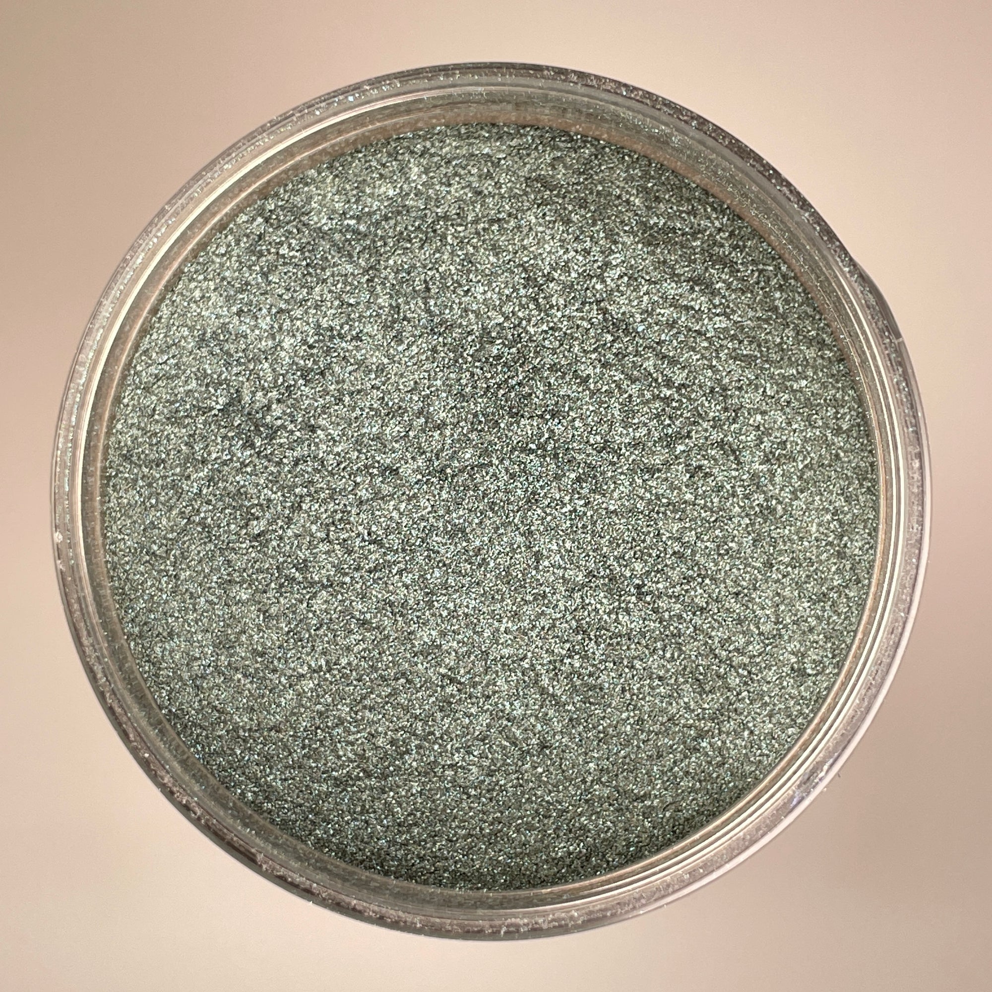 light dull green colour that has grey undertones and is big flaked for a sparkle effect