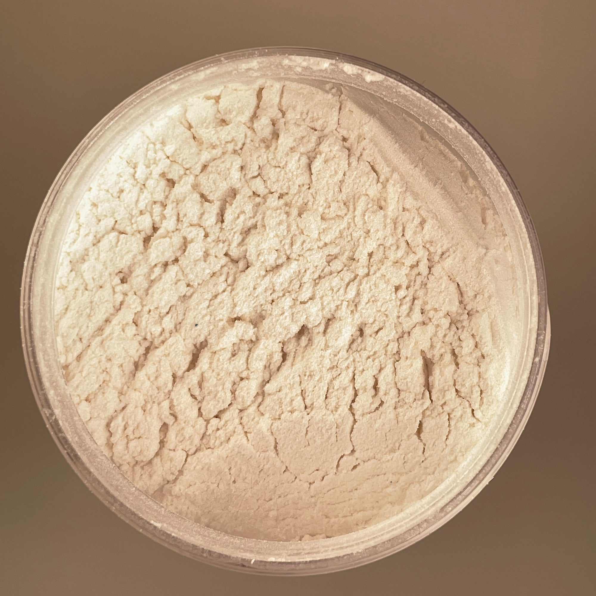 stark white colour arial view of pigment sitting in a round container