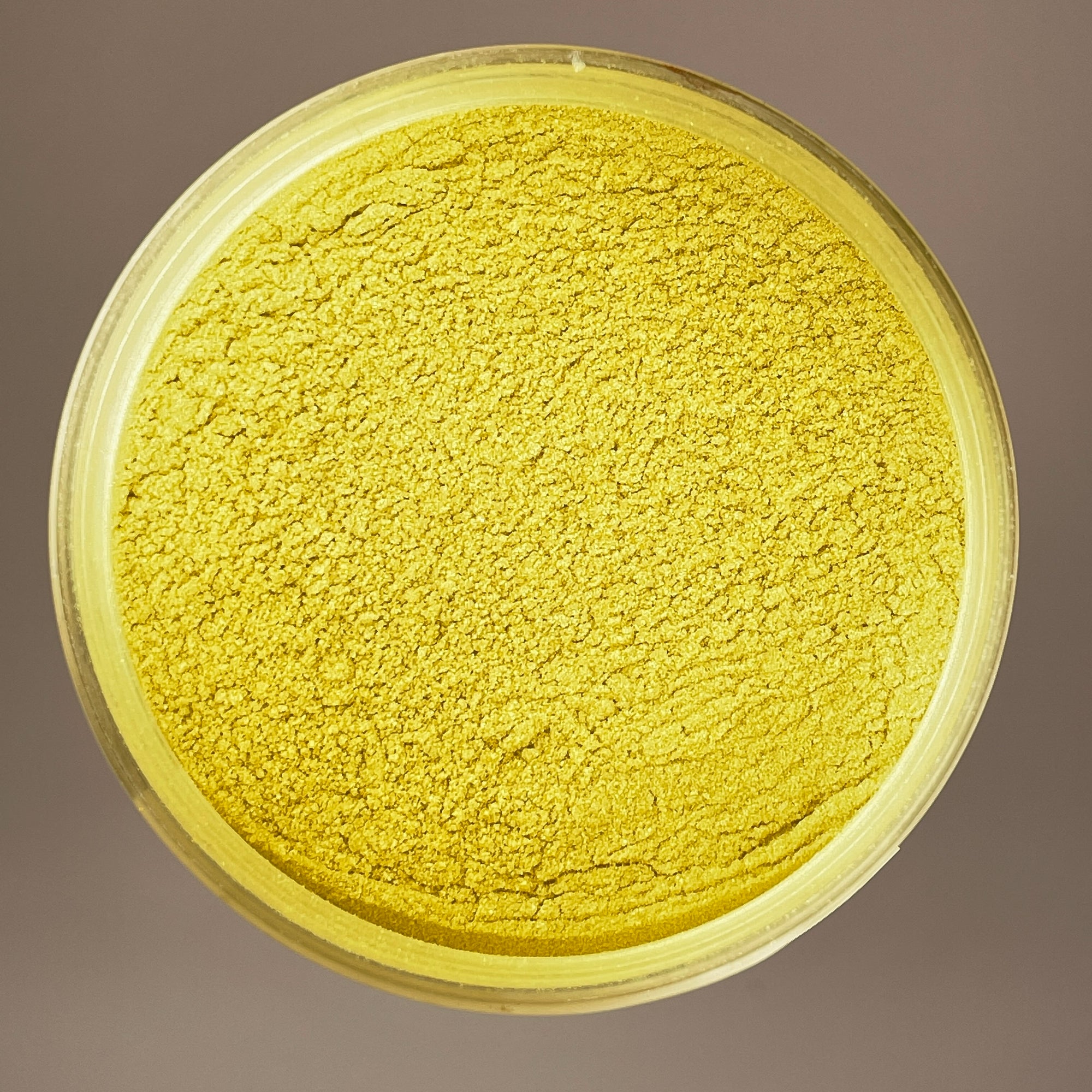 birds eye view shot of mica powder pigment that is a bright yellow colour just like the sun